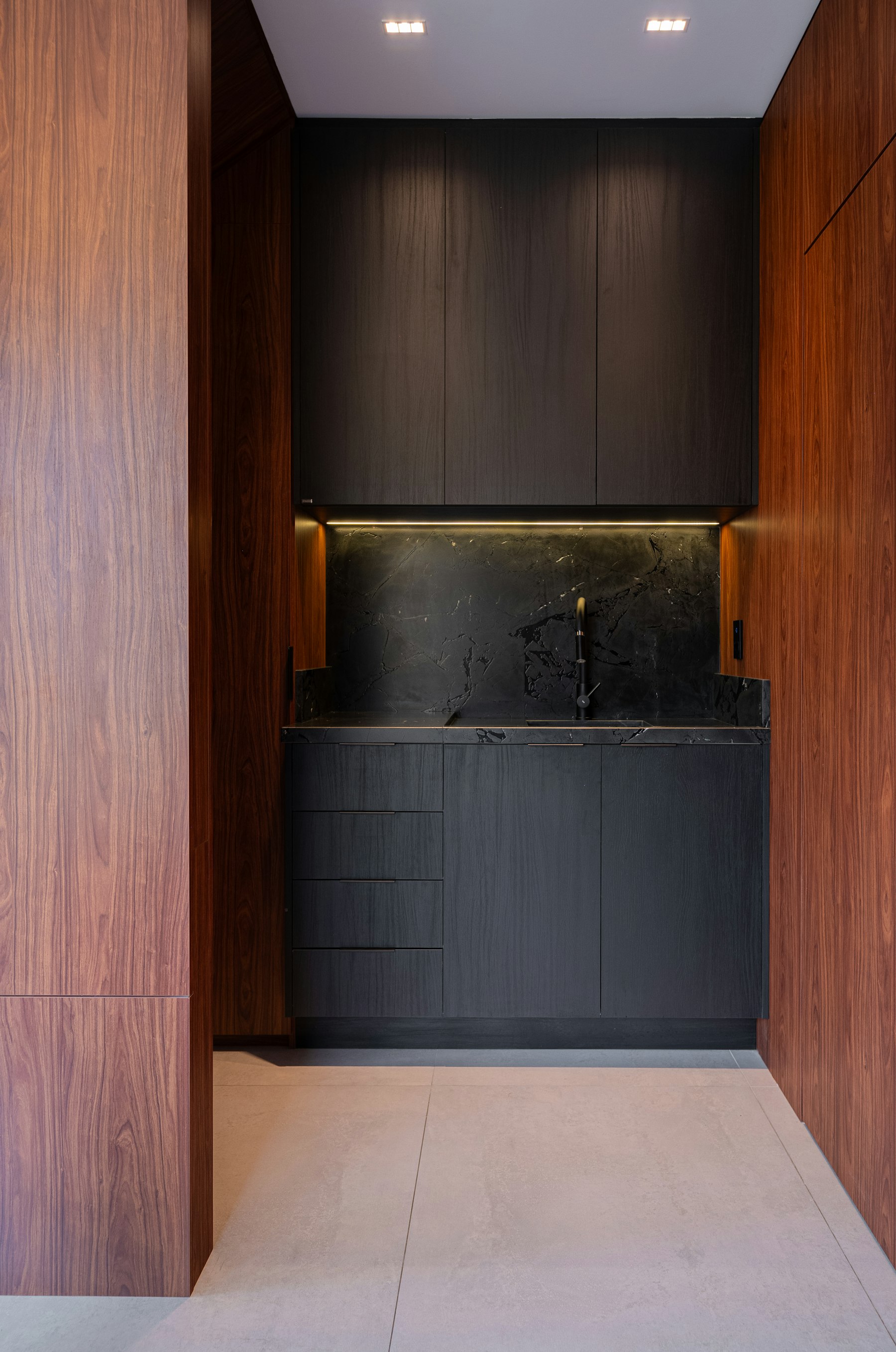 Dark kitchen framed in walnut in a Brooklyn Heights townhouse