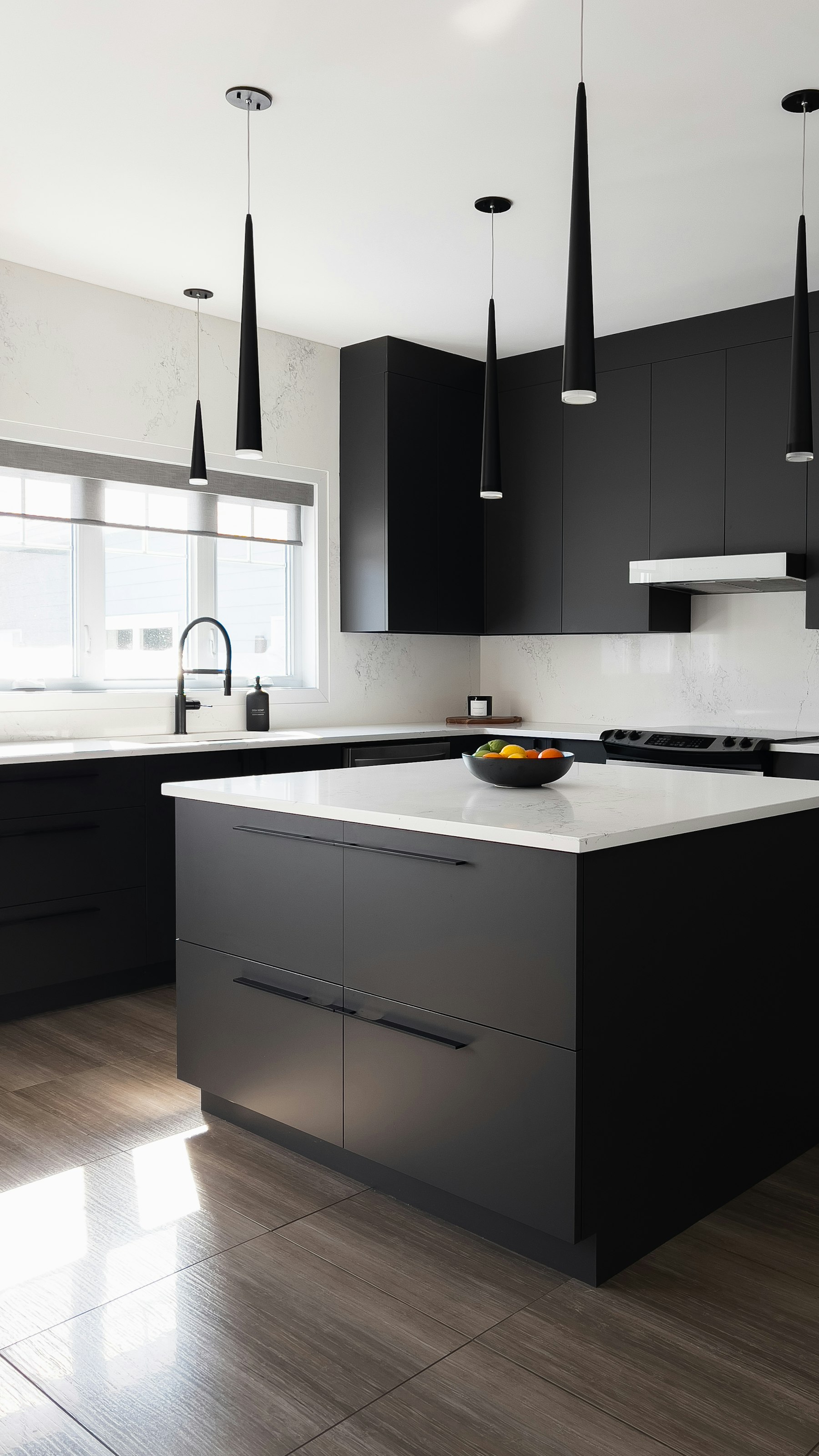 Black cabinets with a white island in a Sag Harbor house
