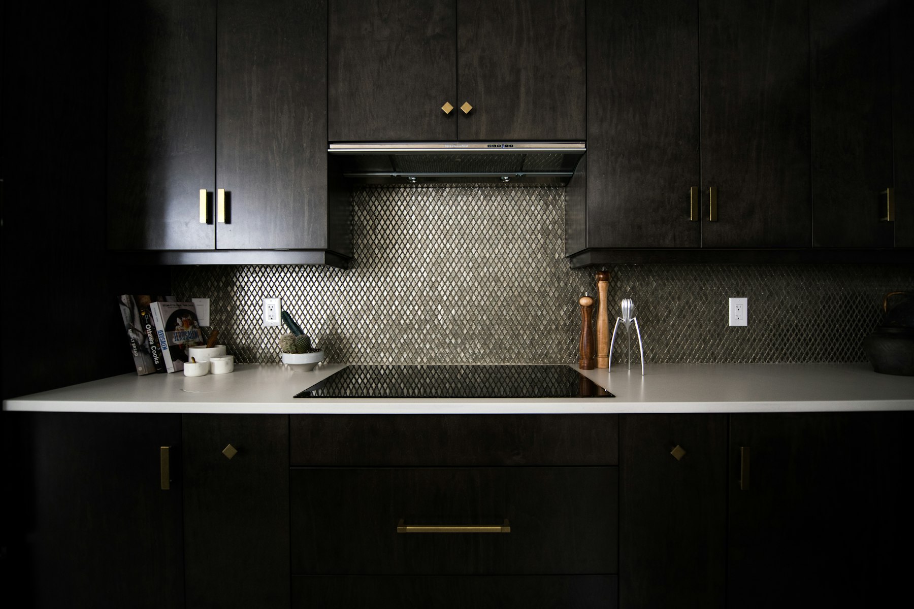 Dark cabinets with a stone worktop in a pre-war apartment