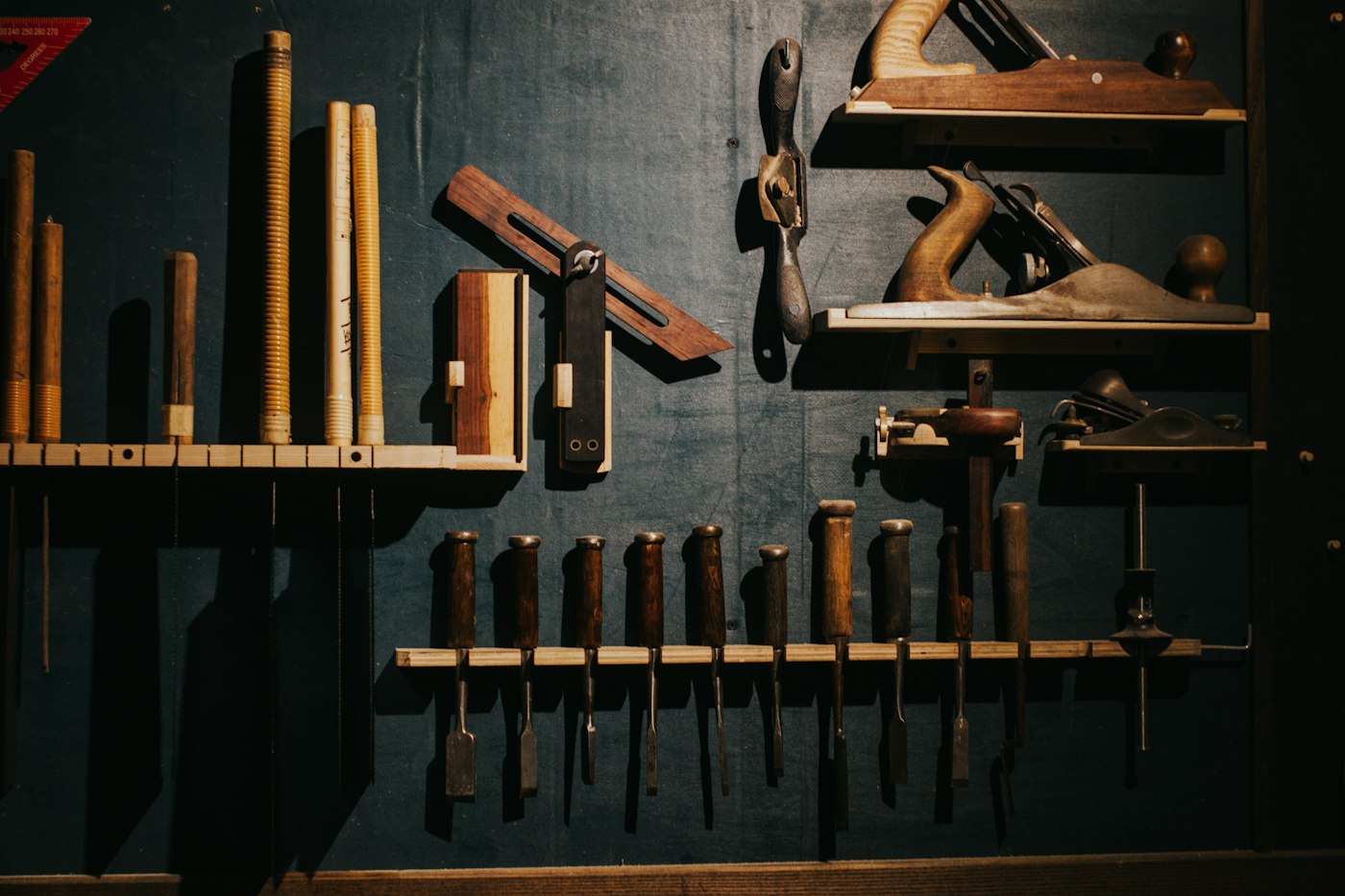 Hand tools on a dark wall